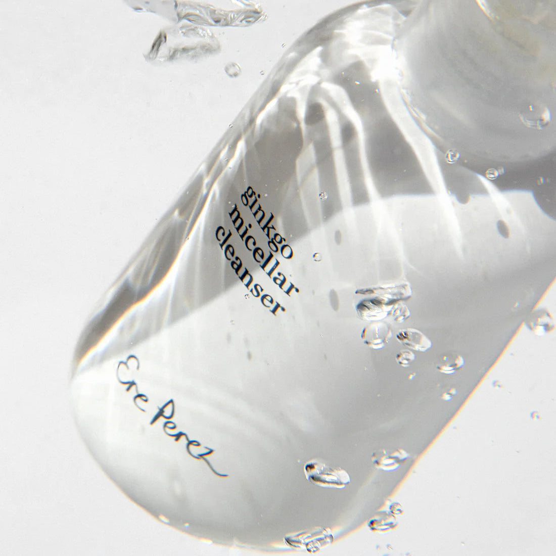 Clear bottle of Eve Perch ginkgo micellar cleanser with bubbles on a light gray background